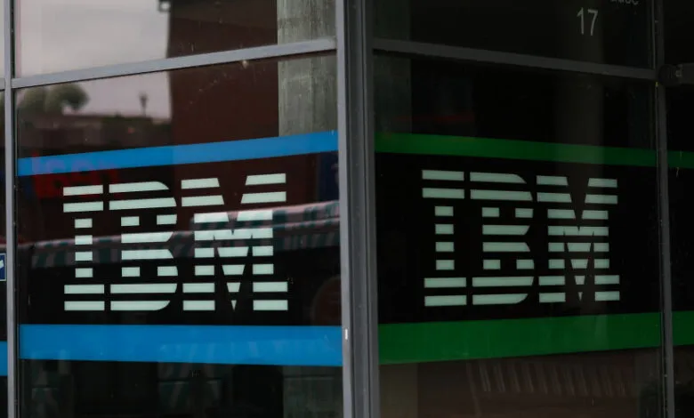 IBM logo displayed on a glass window with blue and green accents.