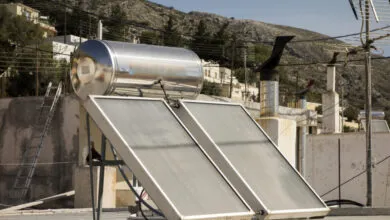 Solar water heater system on rooftop in Greek village.