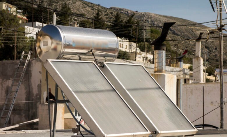 Solar water heater system on rooftop in Greek village.