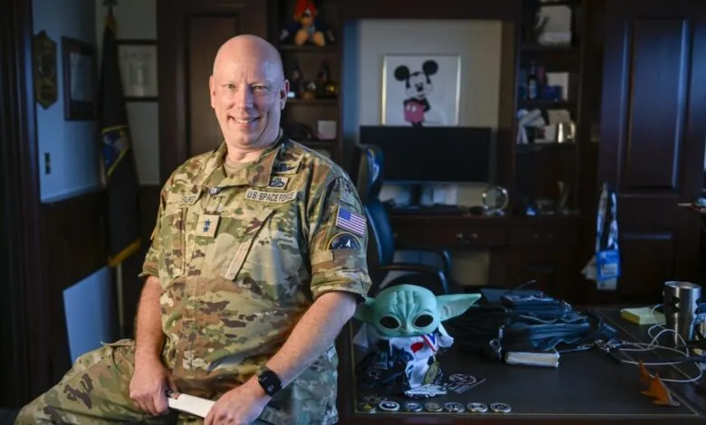 Major General Stephen Purdy in uniform poses in his office.