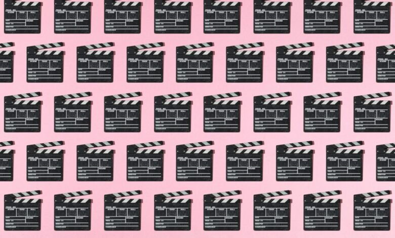 Movie clapperboards arranged in a repeating pattern on pink background.