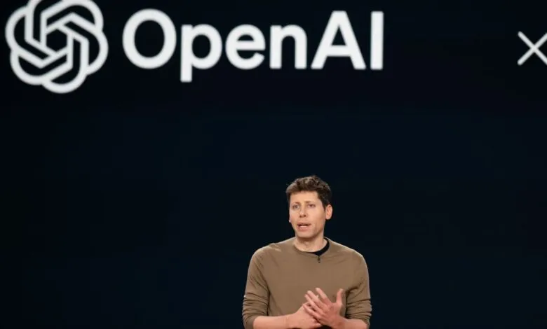 OpenAI CEO Sam Altman speaks on stage at event.