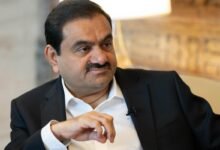 Gautam Adani in a suit, looking off to the side.