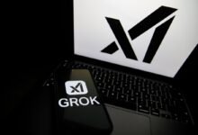 Phone displays Grok logo on laptop, X logo in background.