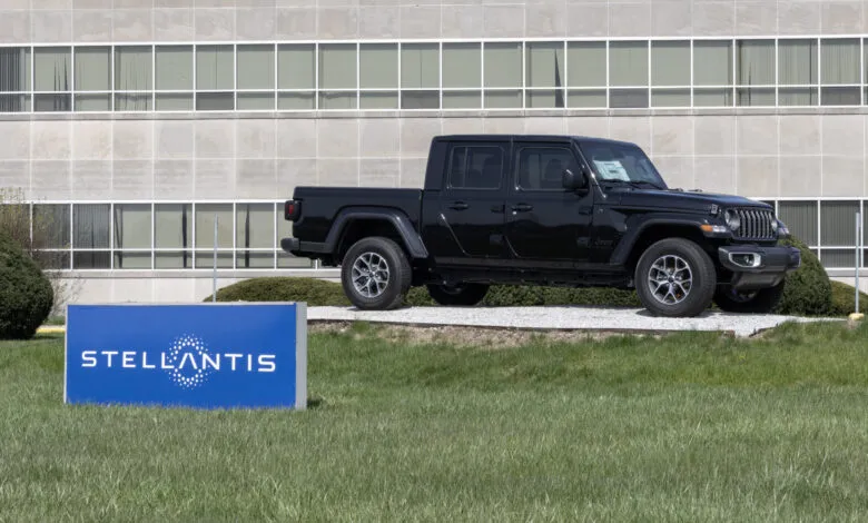 Black Jeep Gladiator parked near a Stellantis plant sign.