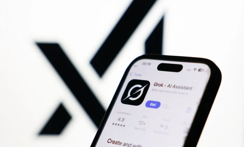 Smartphone displaying Grok AI Assistant app against blurred X logo.