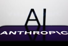 Anthropic AI logo on phone screen with 'AI' text in background.