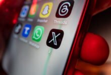 Smartphone screen displaying the new X logo among other app icons.