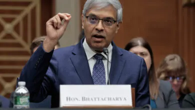 Jayanta Bhattacharya testifies at Senate hearing, raising his hand.