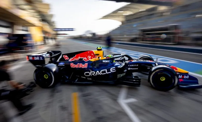 Formula 1 car speeds down track during pre-season testing.