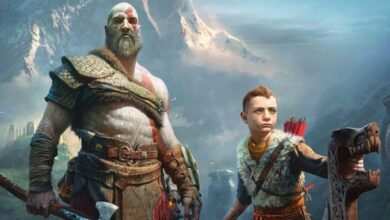 Kratos and Atreus stand together in a mountainous landscape.