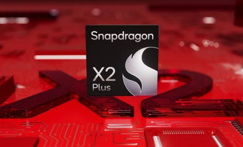 Snapdragon X2 Plus chip on a red circuit board background.