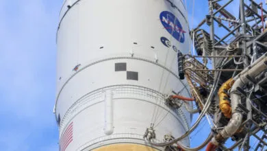 Close-up of a white rocket with the NASA logo and American flag.