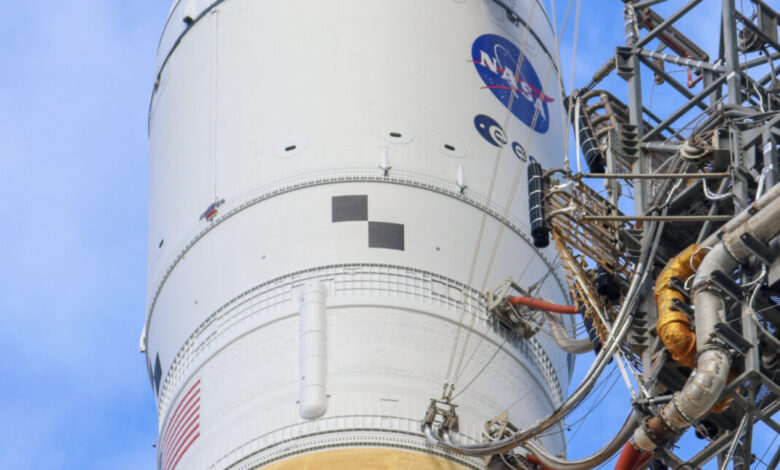 Close-up of a white rocket with the NASA logo and American flag.
