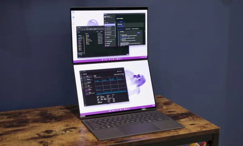 Dual-screen laptop displaying system performance and file explorer.