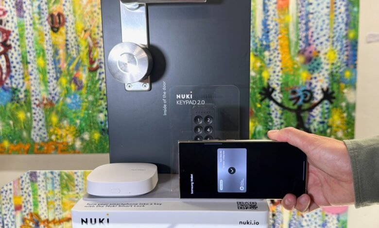 Nuki smart lock system with keypad and phone integration on display.