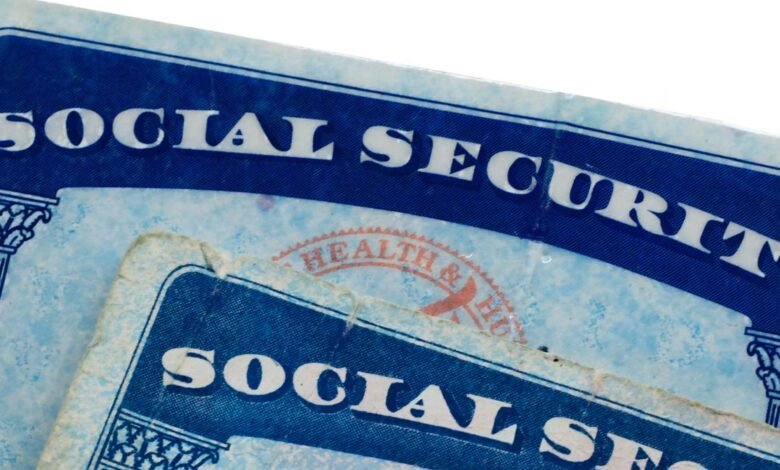 Close-up of two Social Security cards with blue text and decorative borders.