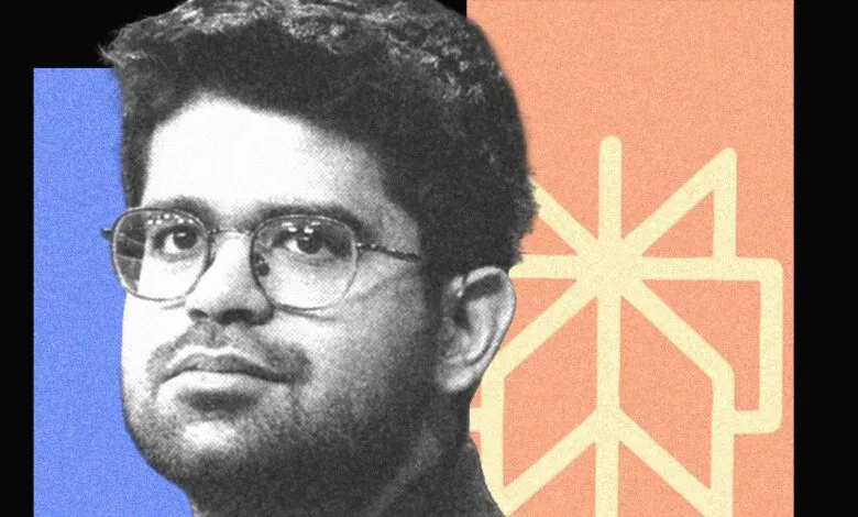 Black and white portrait of a man with glasses against colorful background.