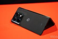 Motorola Razr+ (2023) partially folded on an orange surface.