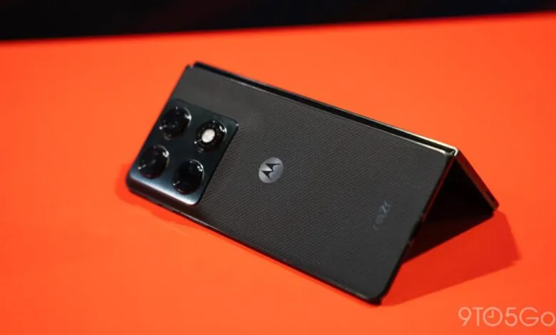 Motorola Razr+ (2023) partially folded on an orange surface.