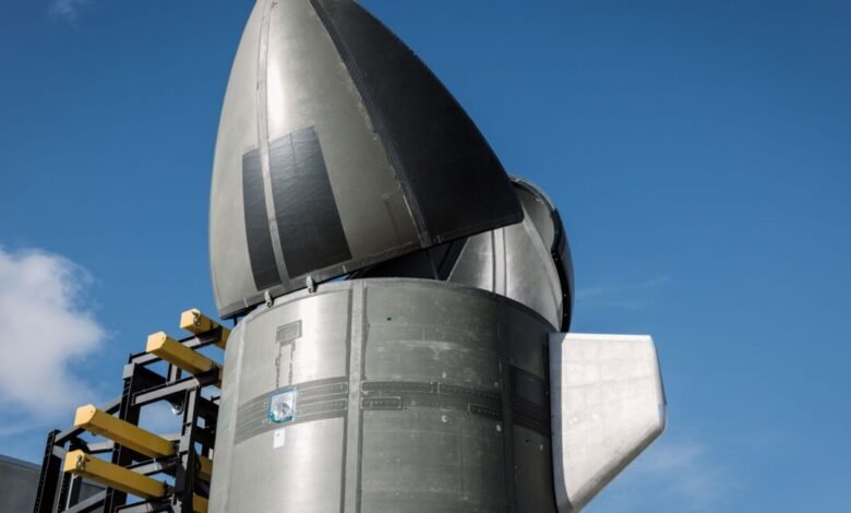Close-up of a rocket nose cone being assembled outdoors on a sunny day.