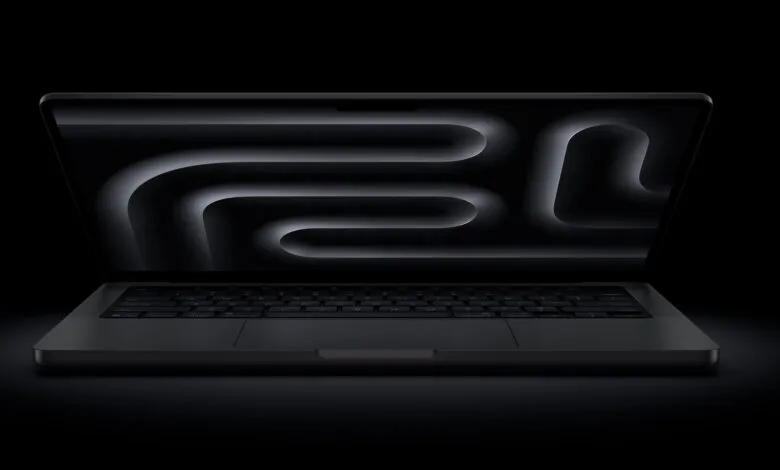 Sleek black laptop with glowing abstract design on screen.