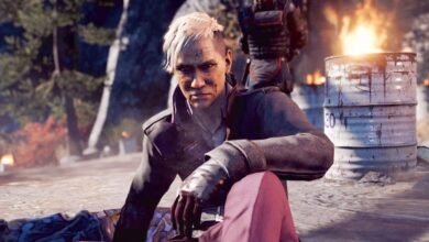 Pagan Min from Far Cry 4 sits with a burning barrel behind him.