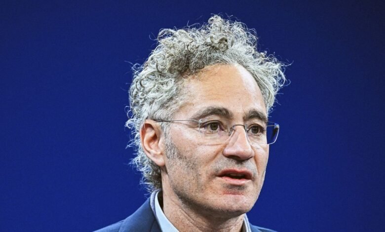 Close-up of Alex Karp, Palantir CEO, wearing glasses and a suit.