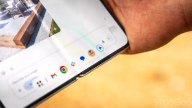 Close-up of a foldable phone displaying a taskbar with app icons.