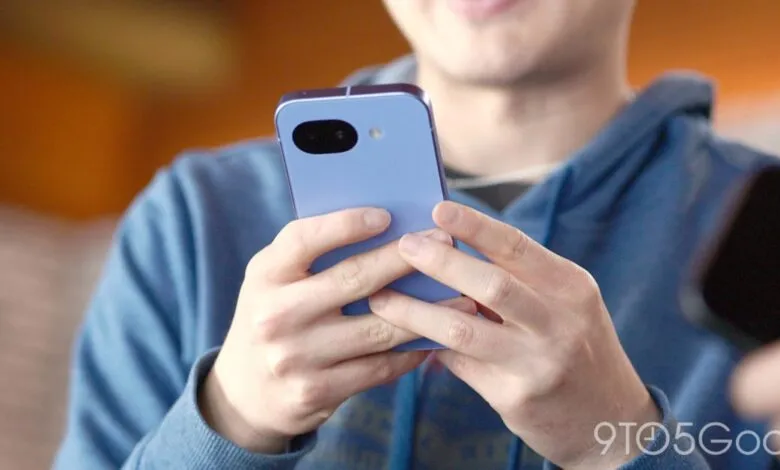 Person holding a lavender-colored smartphone with a unique camera design.