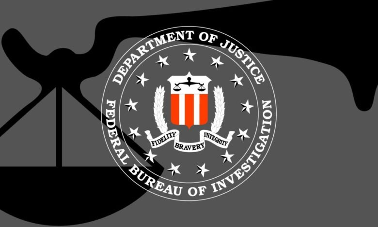 FBI seal with scales of justice on a gray background.