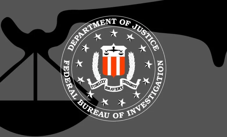 FBI seal with scales of justice on a gray background.
