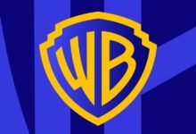 Warner Bros. logo in gold on a blue shield background.