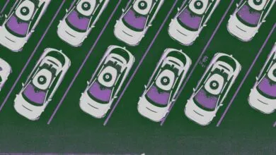 Overhead view of self-driving Waymo taxis parked in a lot.