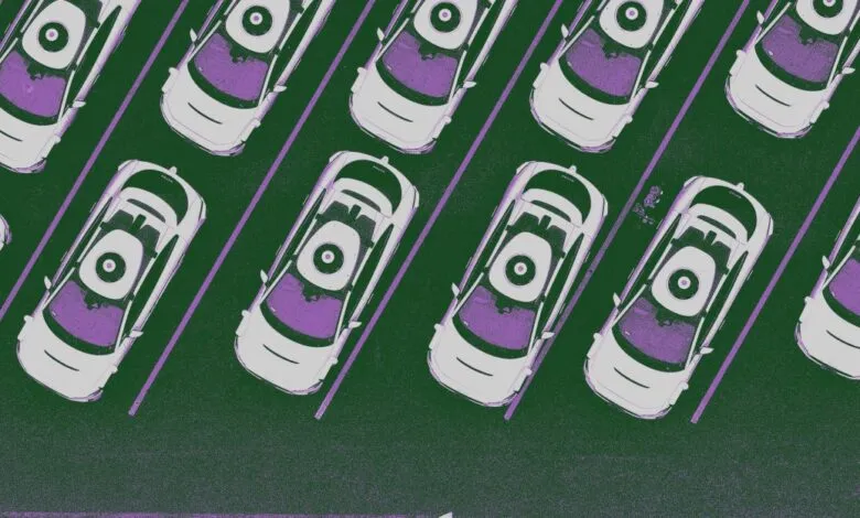 Overhead view of self-driving Waymo taxis parked in a lot.