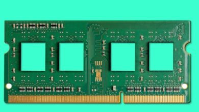 Close-up of a green computer RAM module with gold connectors.