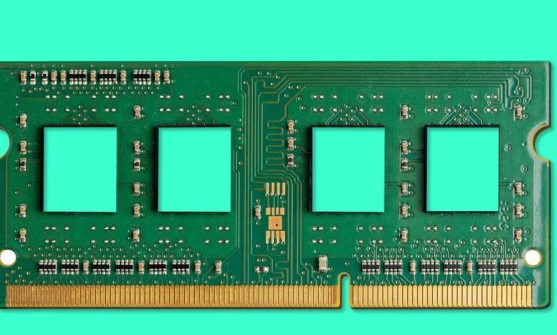 Close-up of a green computer RAM module with gold connectors.