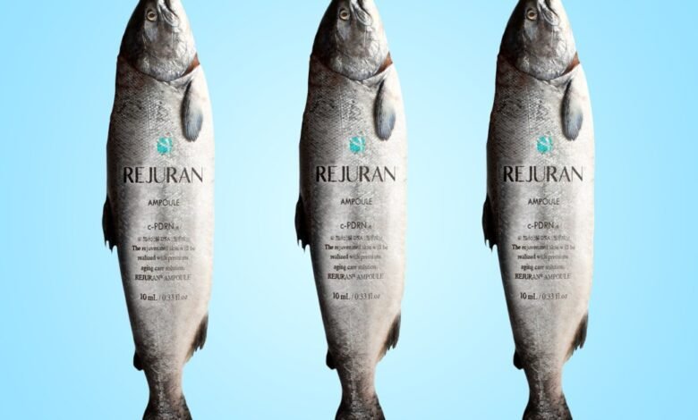 Three salmon with skincare labels on a light blue background.
