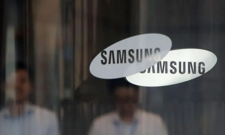 Overlapping Samsung logos on glass with blurred reflections.