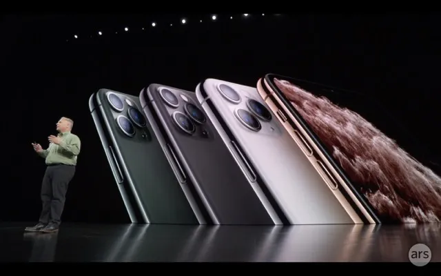 Man presenting iPhone 11 models in green, gray, white, and gold.