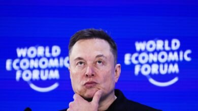 Elon Musk at World Economic Forum, looking upwards thoughtfully.
