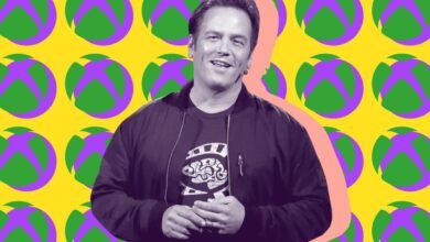 Phil Spencer, head of Xbox, smiles against a vibrant Xbox-themed background.