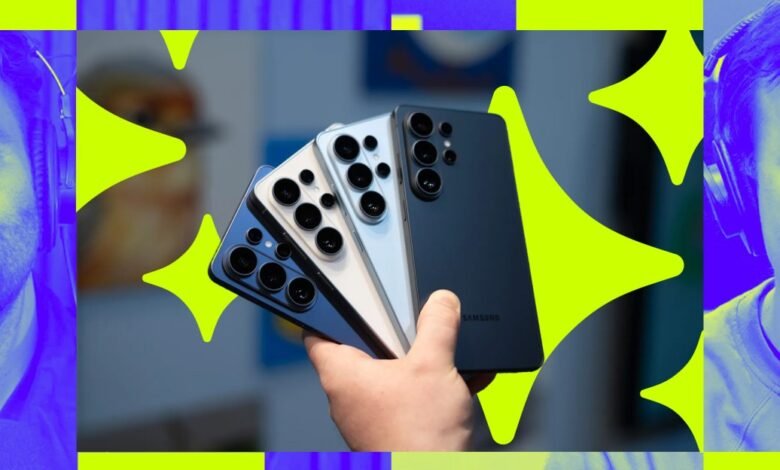 Hand holds three Samsung Galaxy S23 Ultra phones in blue, white, and black.