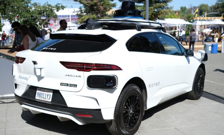 White Jaguar I-PACE with Waymo self-driving technology on display.