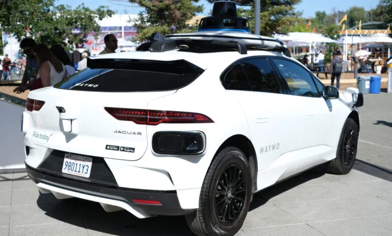 White Jaguar I-PACE with Waymo self-driving technology on display.