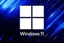 Windows 11 logo with four white squares on a blue background.