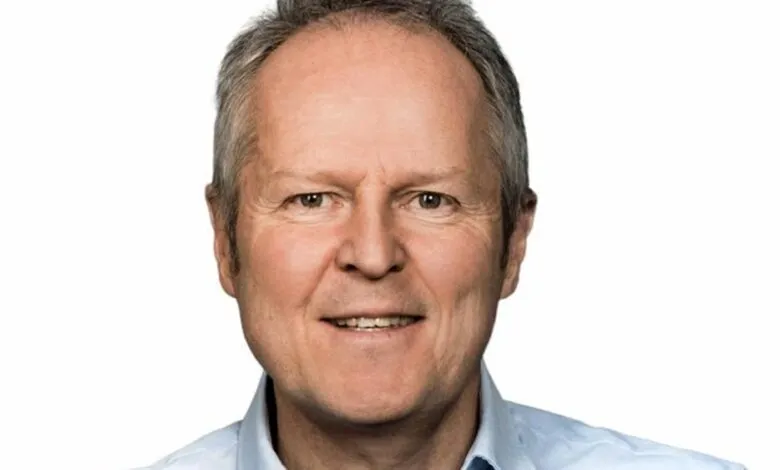 Close-up portrait of Yves Guillemot, CEO of Ubisoft, smiling slightly.