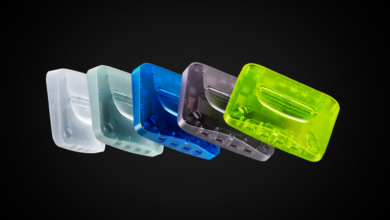 Five translucent Analogue 3D consoles in white, teal, blue, gray, and green.