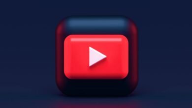 3D rendering of the YouTube play button icon on a dark background.