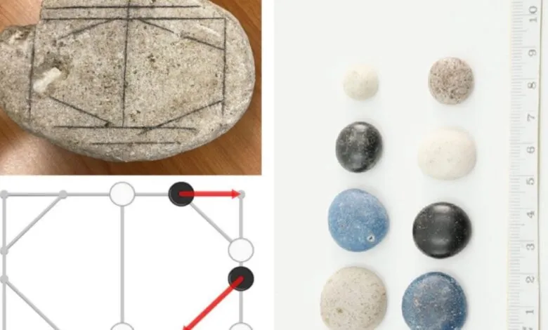 Ancient Roman game board etched on stone with playing pieces.